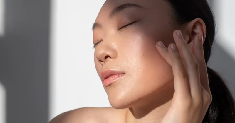 Close-up of woman’s glowing skin after facial rejuvenation treatment at Two Chicks Aesthetics in Port Jefferson NY