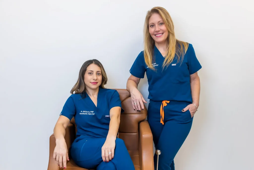 Two Chicks Aesthetics injector specialists posing in consultation room at the medspa in Port Jefferson NY