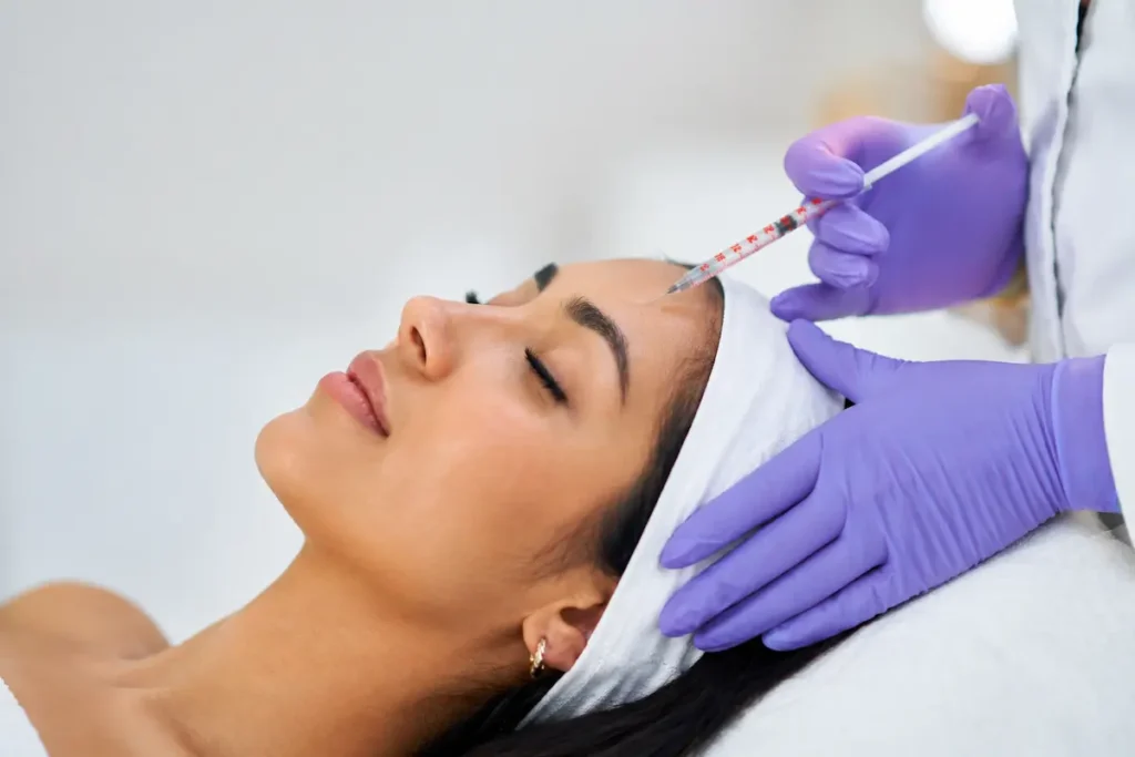 Experienced Botox Providers in Port Jefferson — Safe, Natural-Looking Results for Youthful Skin 4 Close-up of a woman undergoing a facial injection procedure by experienced botox providers in a modern aesthetic clinic.